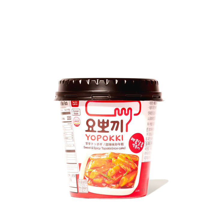 Instant Yopokki cup with sweet and spicy tteokbokki (rice cake) on a white background.