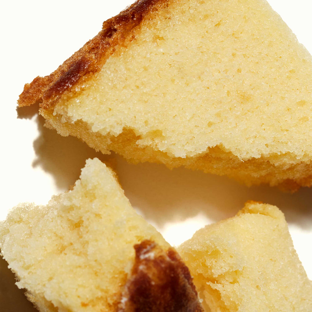 Slices of golden-brown Sakura Castella Cake: Duo Pack on a white background.