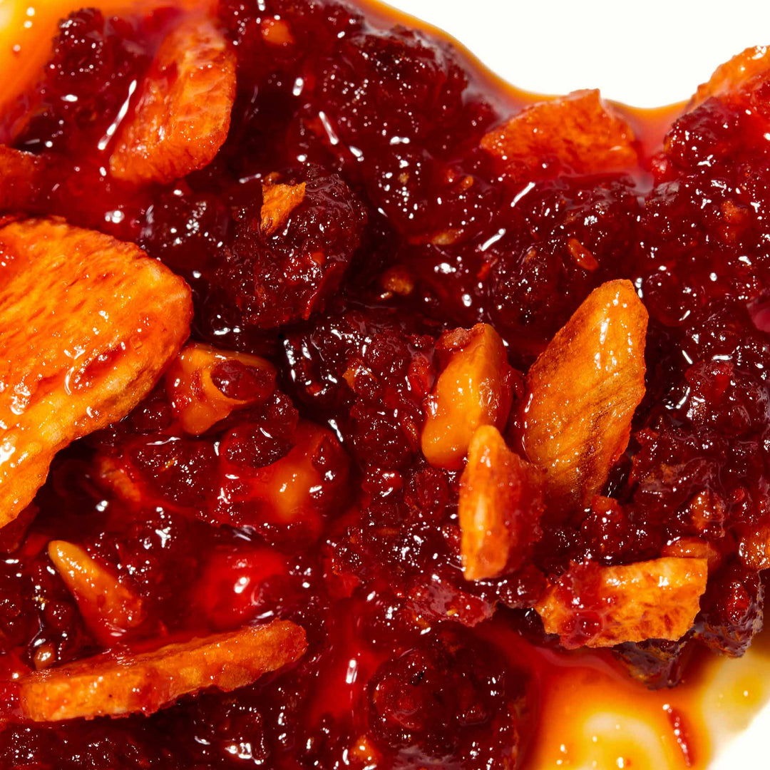 Close-up of a chunky berry compote with almond slivers, a staple in the MULTI Japanese Condiments Pack pantry.