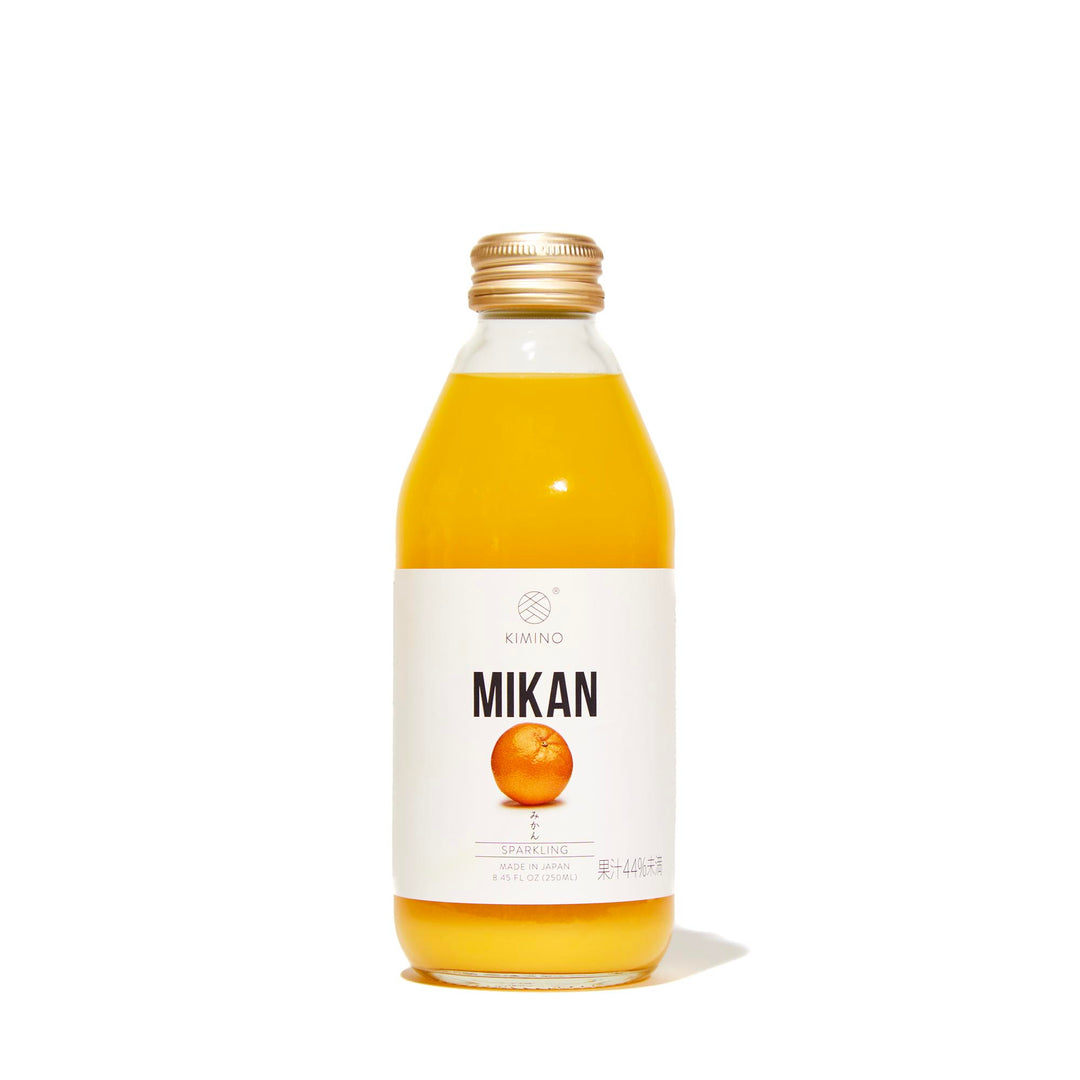 A bottle of Kimino Sparkling Juice: Mikan Orange on a white background.