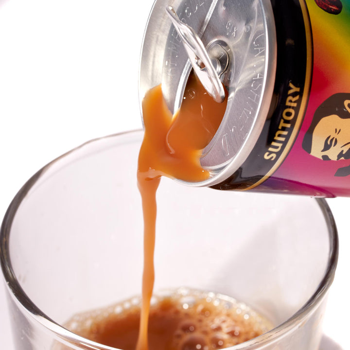 A can of Suntory BOSS Rainbow Mountain Blend Canned Coffee being poured into a glass.