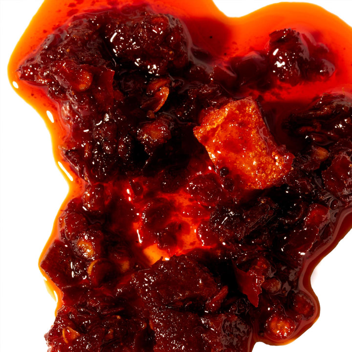Lao Gan Ma Chili Oil with Fermented Soybeans on a white background.