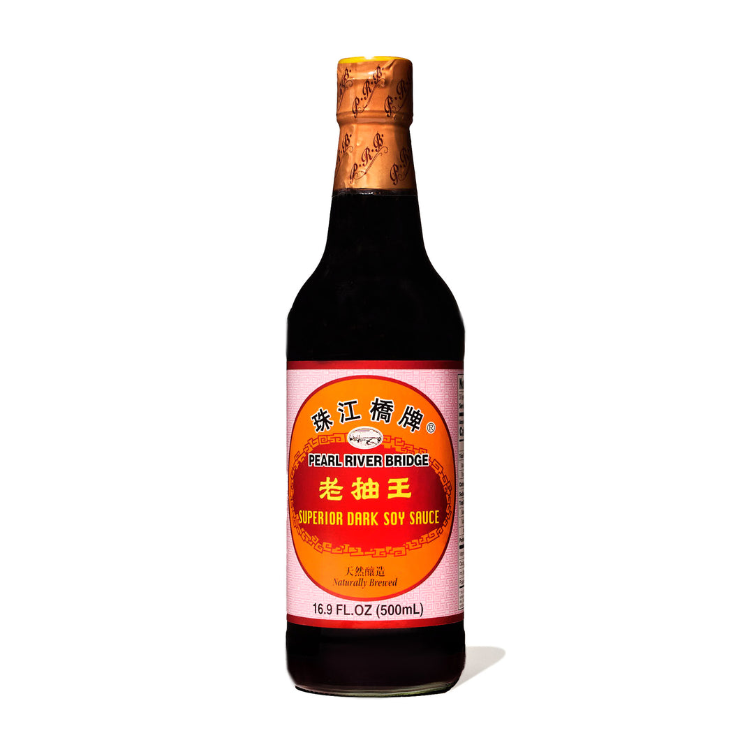 A bottle of Pearl River Bridge Superior Lao Chou Dark Soy Sauce on a white background.