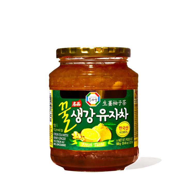 A jar of Surasang Yuzu Citron Tea with Honey & Ginger, a Korean tea known for its high content of vitamin C, on a white background.