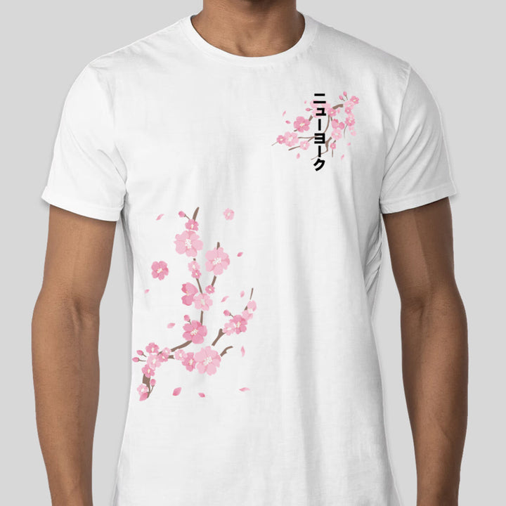Man wearing a Bokksu Sakura T-shirt with a sakura print and Katakana text.