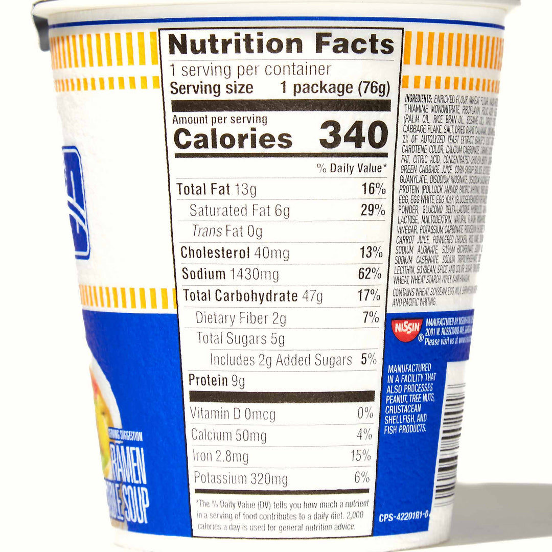 A cup of Nissin Cup Noodle: Seafood with nutrition facts on it.