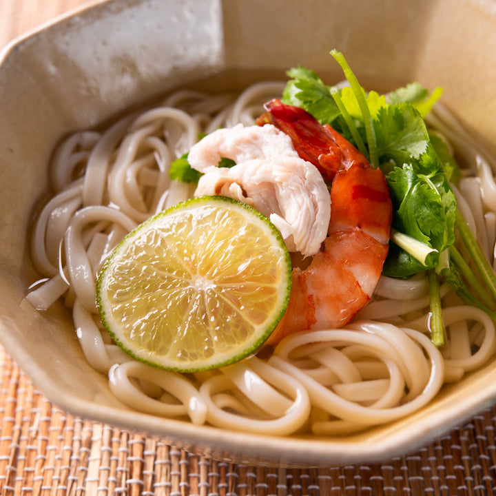 A bowl of Kuze Fuku noodle soup with shrimp and lime.