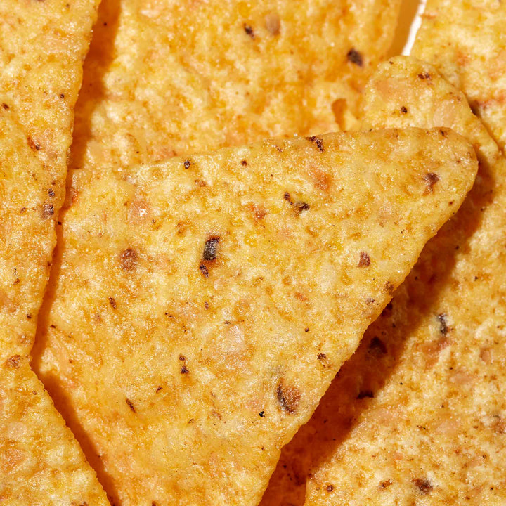 A close up of Japanese Doritos: Mild Salt tortilla chips on a white plate, made by Fritolay.