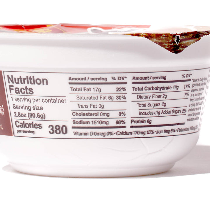 Close-up of a nutrition label on a Hikari Menraku: Variety Pack ramen container listing calories, fat content, umami level, and other dietary information.
