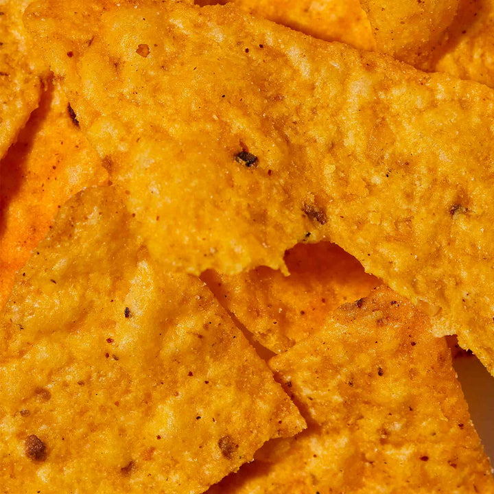 Close-up view of a flavor explosion in a variety pack of seasoned Doritos tortilla chips.