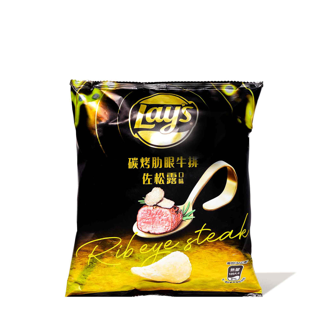 A bag of Lay's Potato Chips: Rib Eye Steak with Black Truffle on a white background.