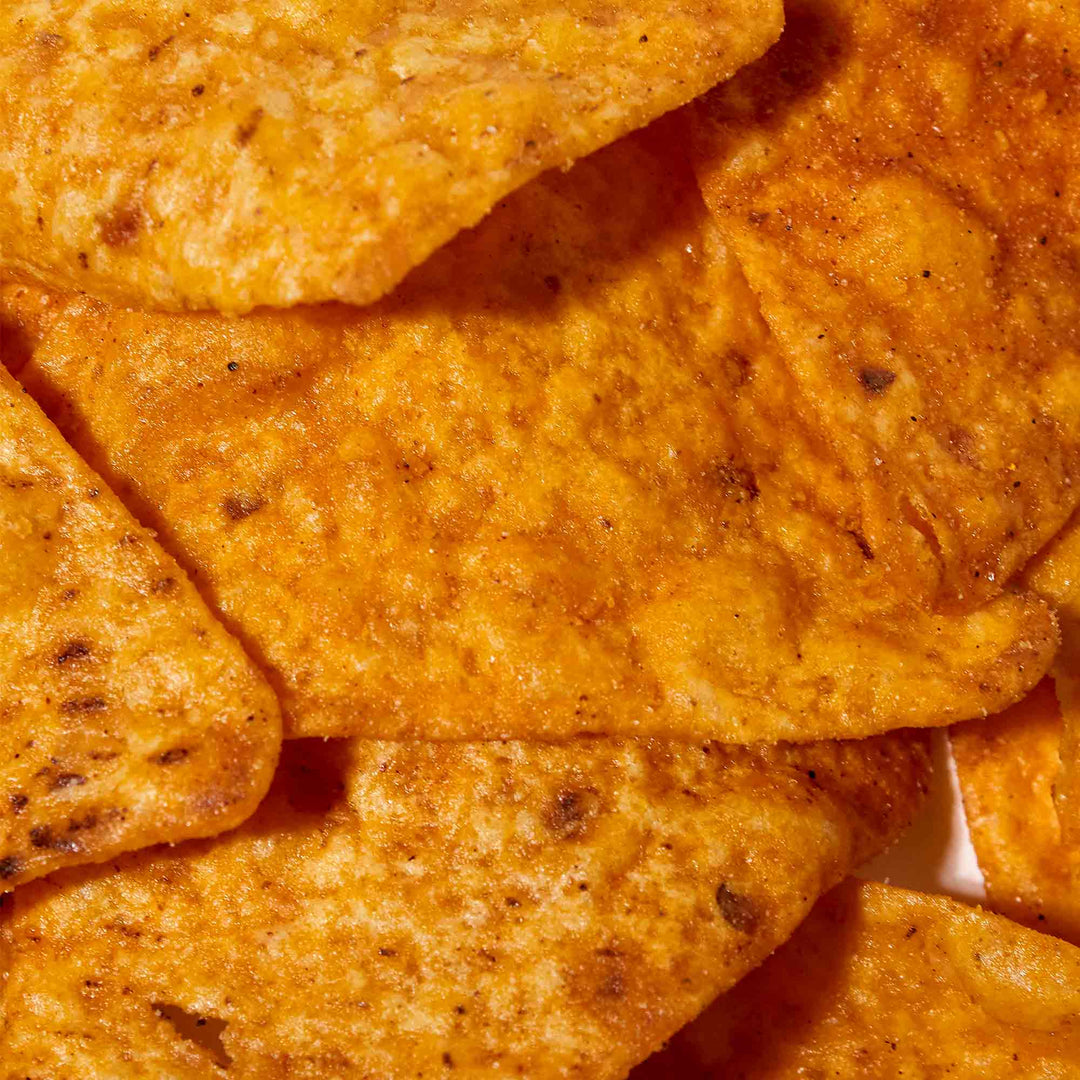 Close-up view of a flavor explosion in a Doritos: Variety Pack of seasoned Doritos tortilla chips.