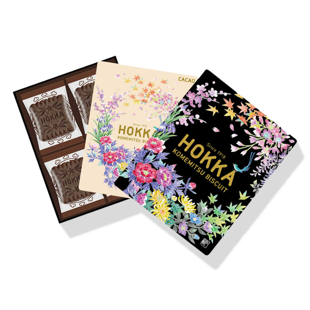 A box of Hokka Komemitsu Cacao Biscuits: Kaga Yuzen (12 pieces) with floral designs on them, perfect for foodie friends during the holiday season. Brand Name: Hokuriku Seika