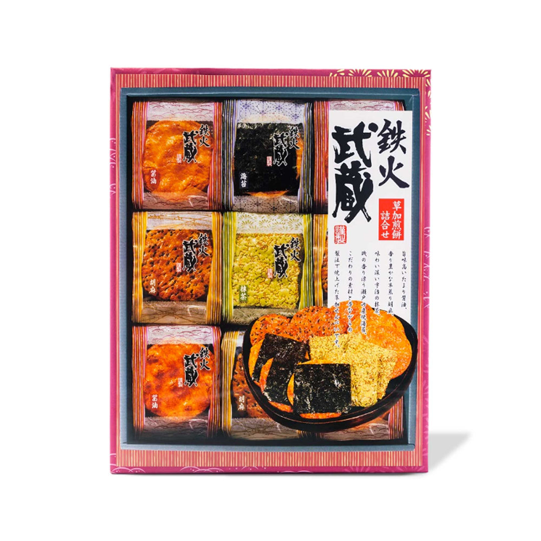 A Honda box filled with Tekka Musashi assorted crunchy rice crackers (27 pieces), featuring all adorned with Japanese writing. Perfect for Japanese snack lovers.