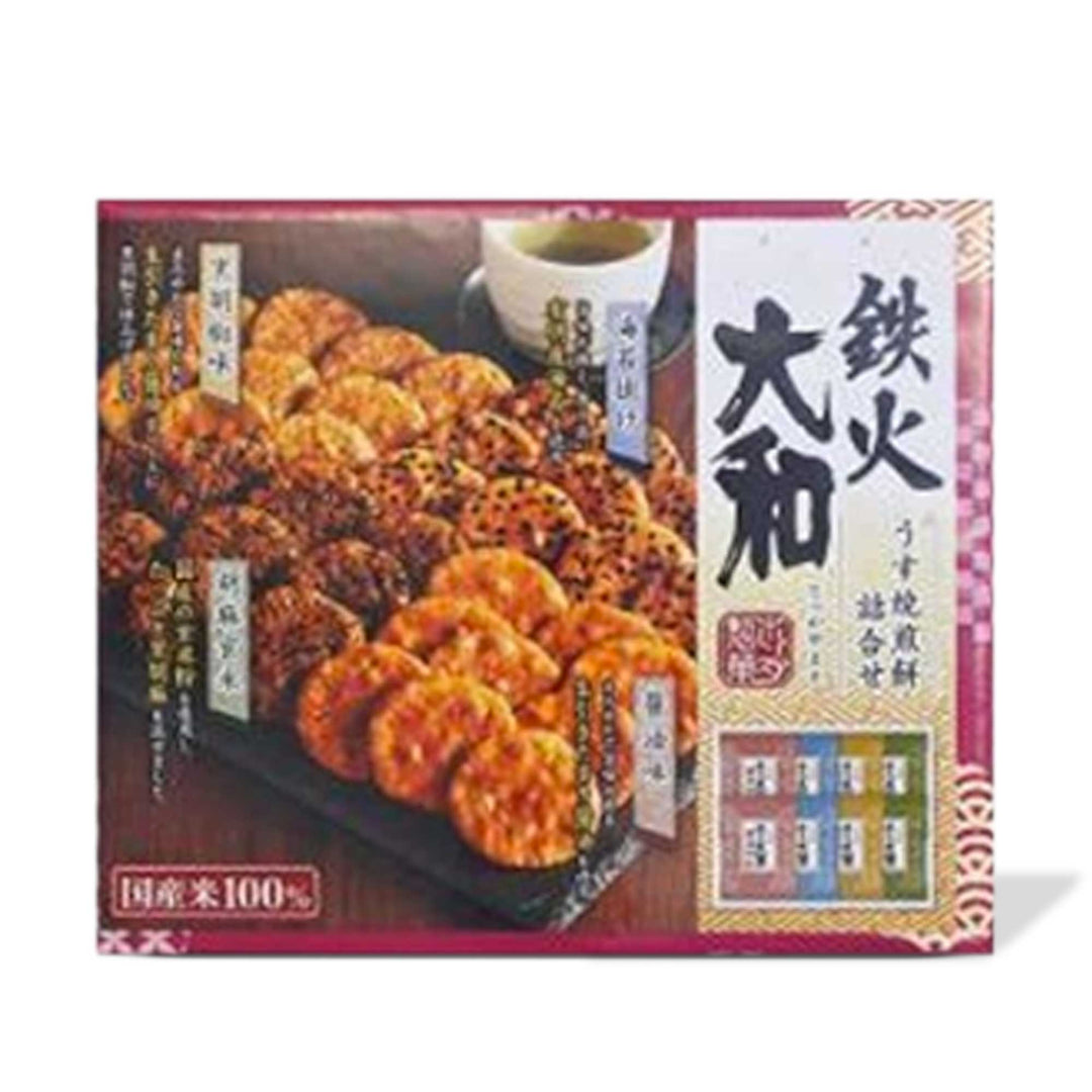 An assorted box of Tekka Yamato Thin Rice Crackers by Honda with Asian writing on it, offering a delightful snack option.