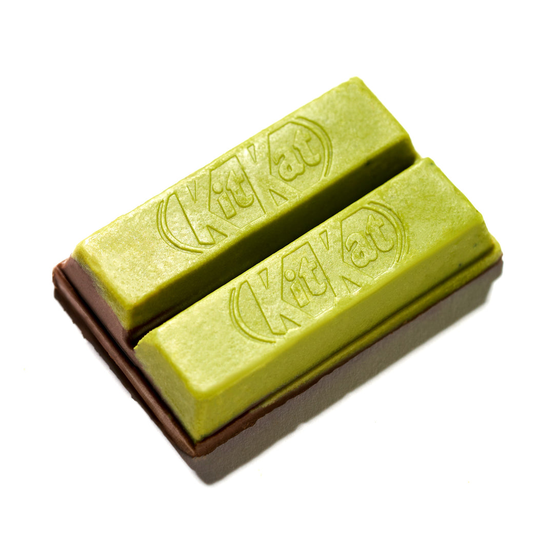 Two sticks of Green Tea Double Layer Japanese Kit Kat by Nestle Japan on a white background.