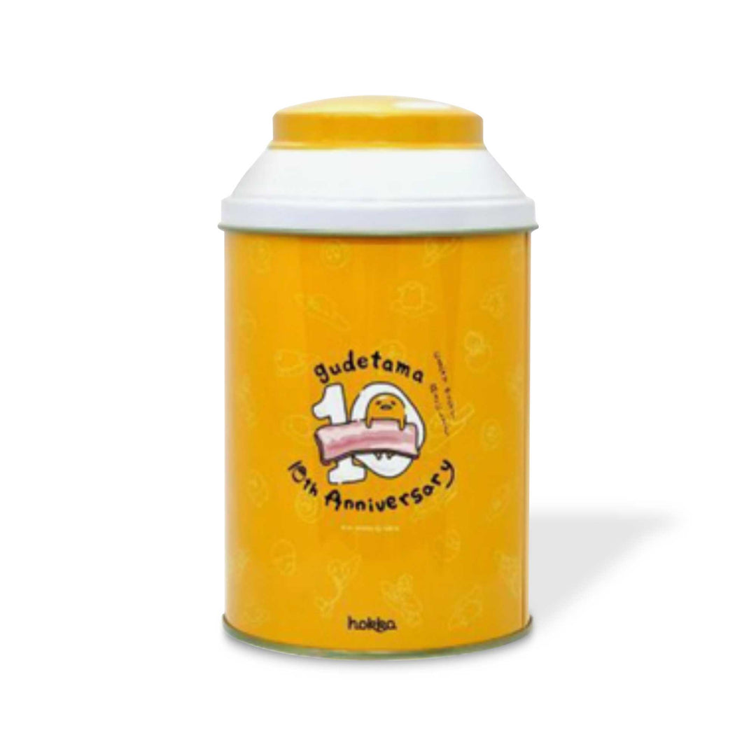 A yellow Hokka Gudetama Biscuit Gift Tin container with a Gudetama logo on it.