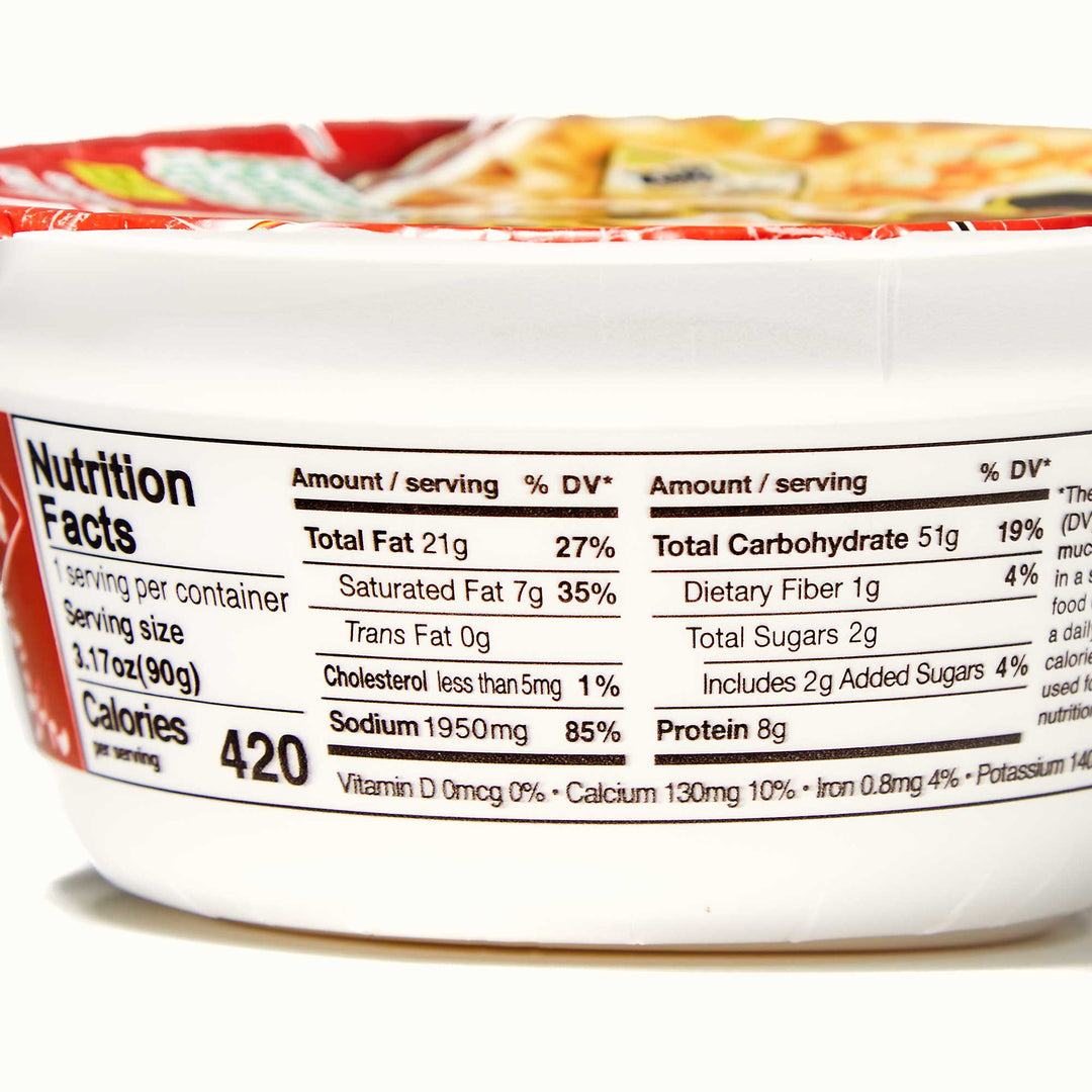 Close-up of a nutrition facts label on a Hikari Menraku: Variety Pack ramen container showing calorie content and percentages of daily values for various nutrients, including umami.