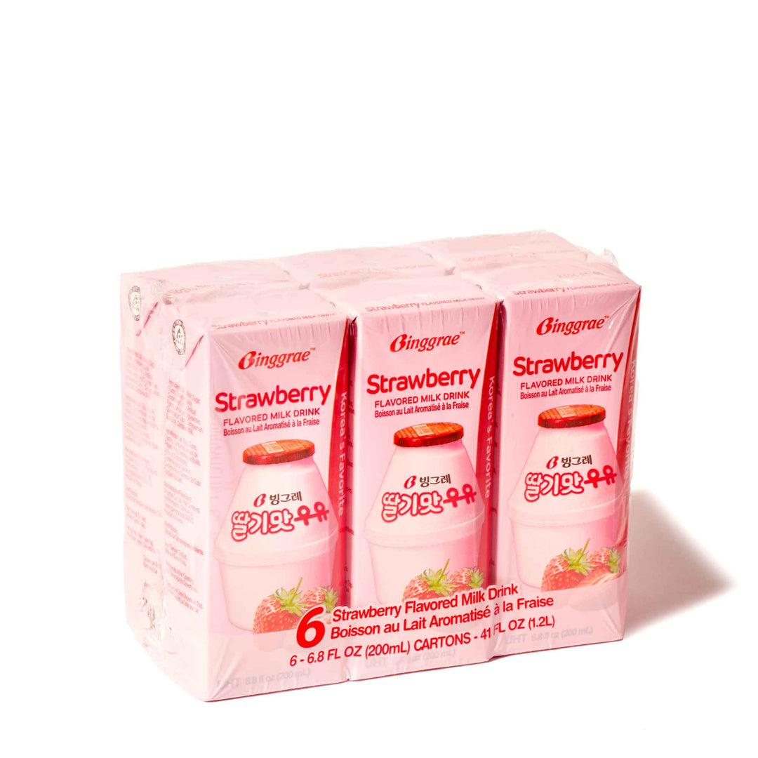 Four boxes of Binggrae Strawberry Flavored Milk (6-pack) on a white background.