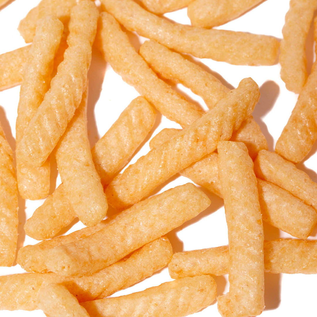 A pile of Calbee Shrimp Chips: Party Size on a white surface.