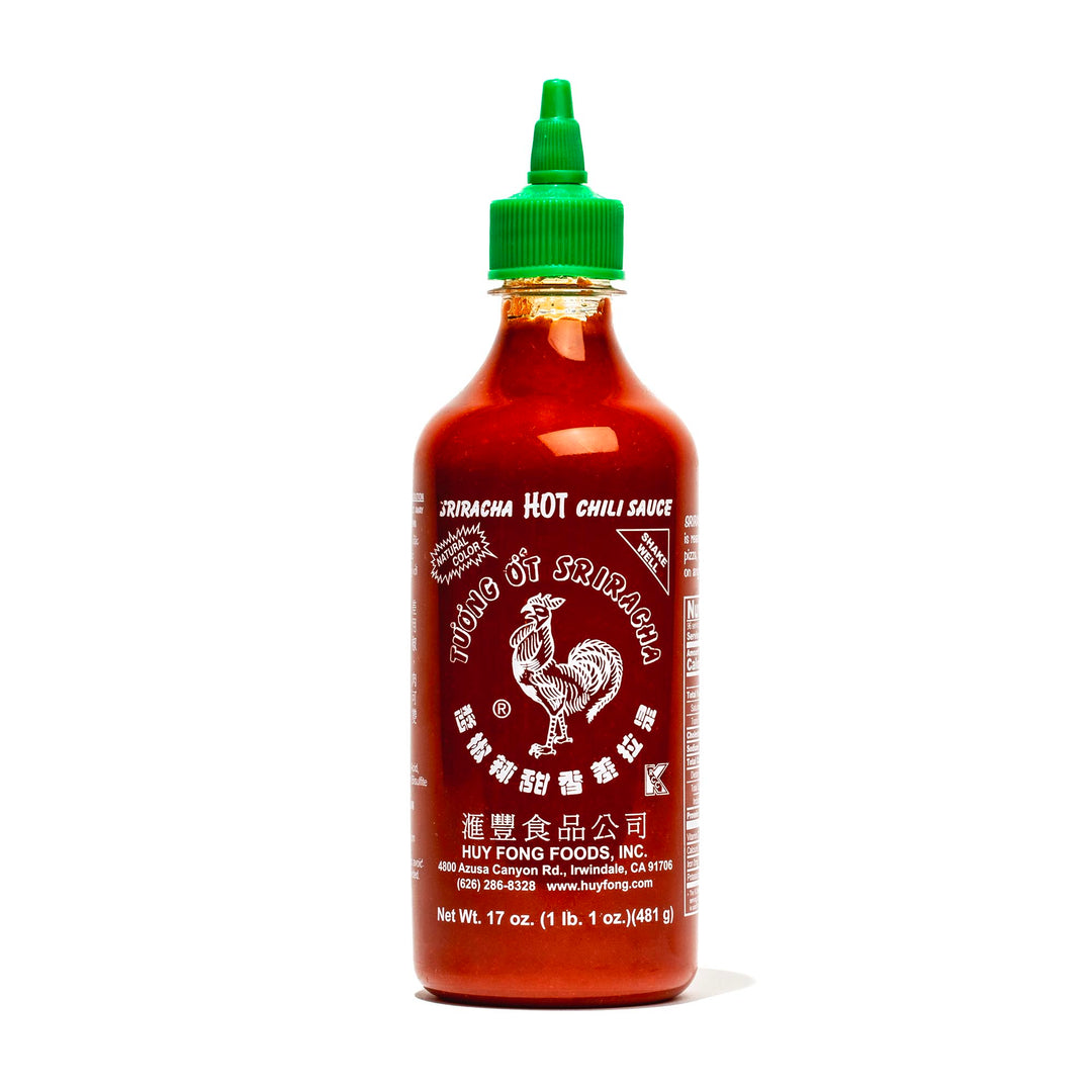 A bottle of Huy Fong Sriracha Hot Chili Sauce on a white background.