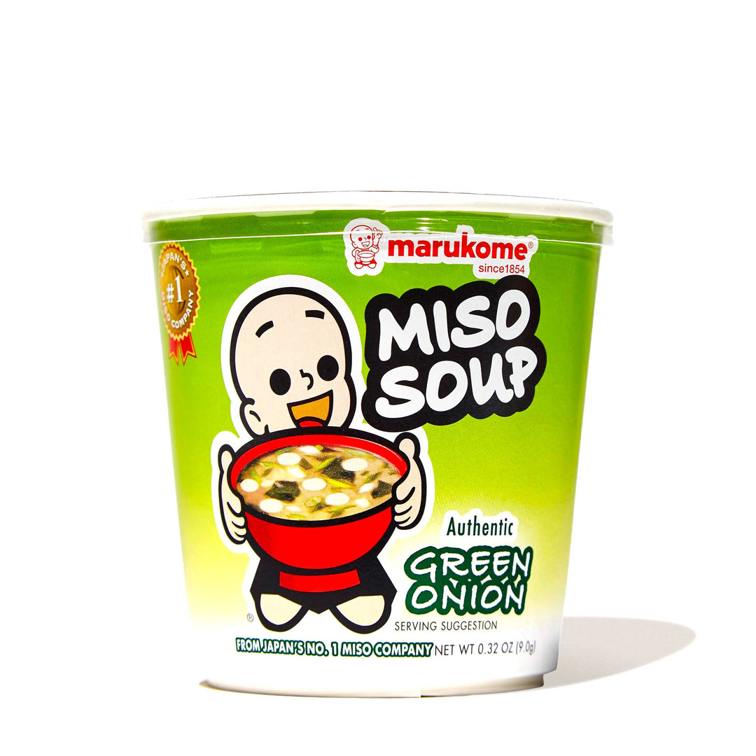 A bowl of Marukome Instant Miso Soup Cup: Green Onion with a cartoon character on it.
