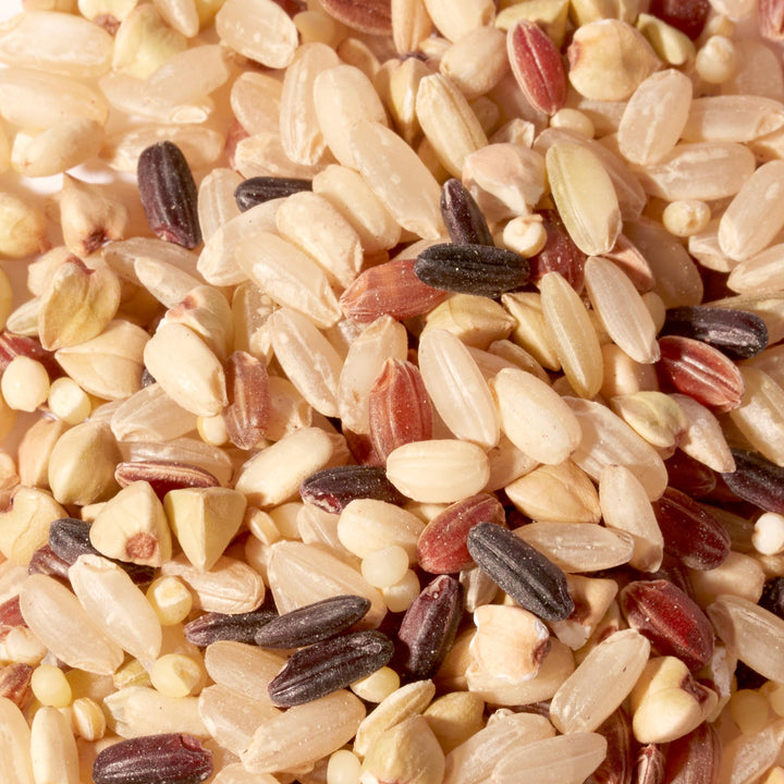 A close up image of a pile of Nishiki 7 Grain Mix For Rice by Nishiki.