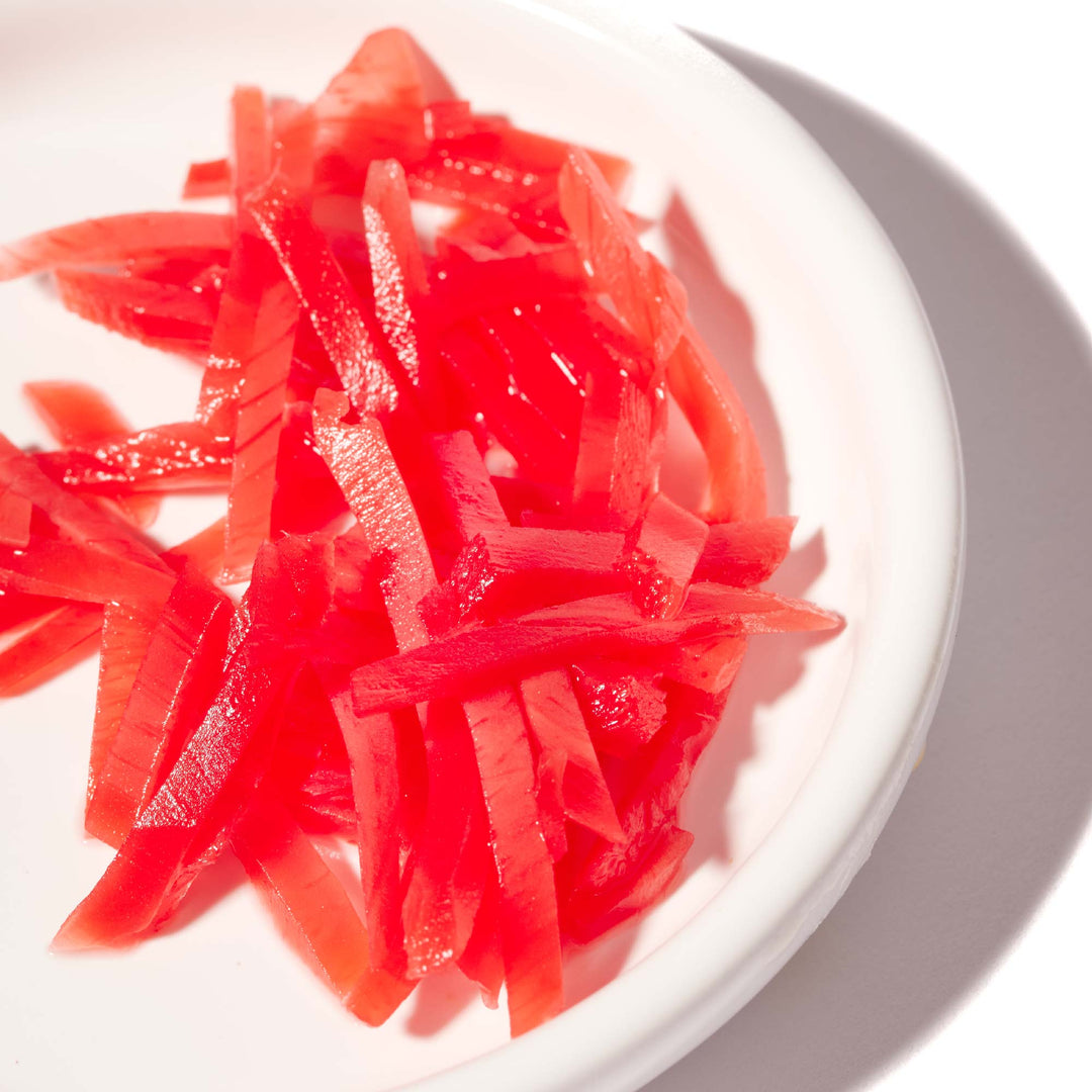 A white plate with Wel-Pac Kizami Shoga Shredded Pickled Ginger on it.