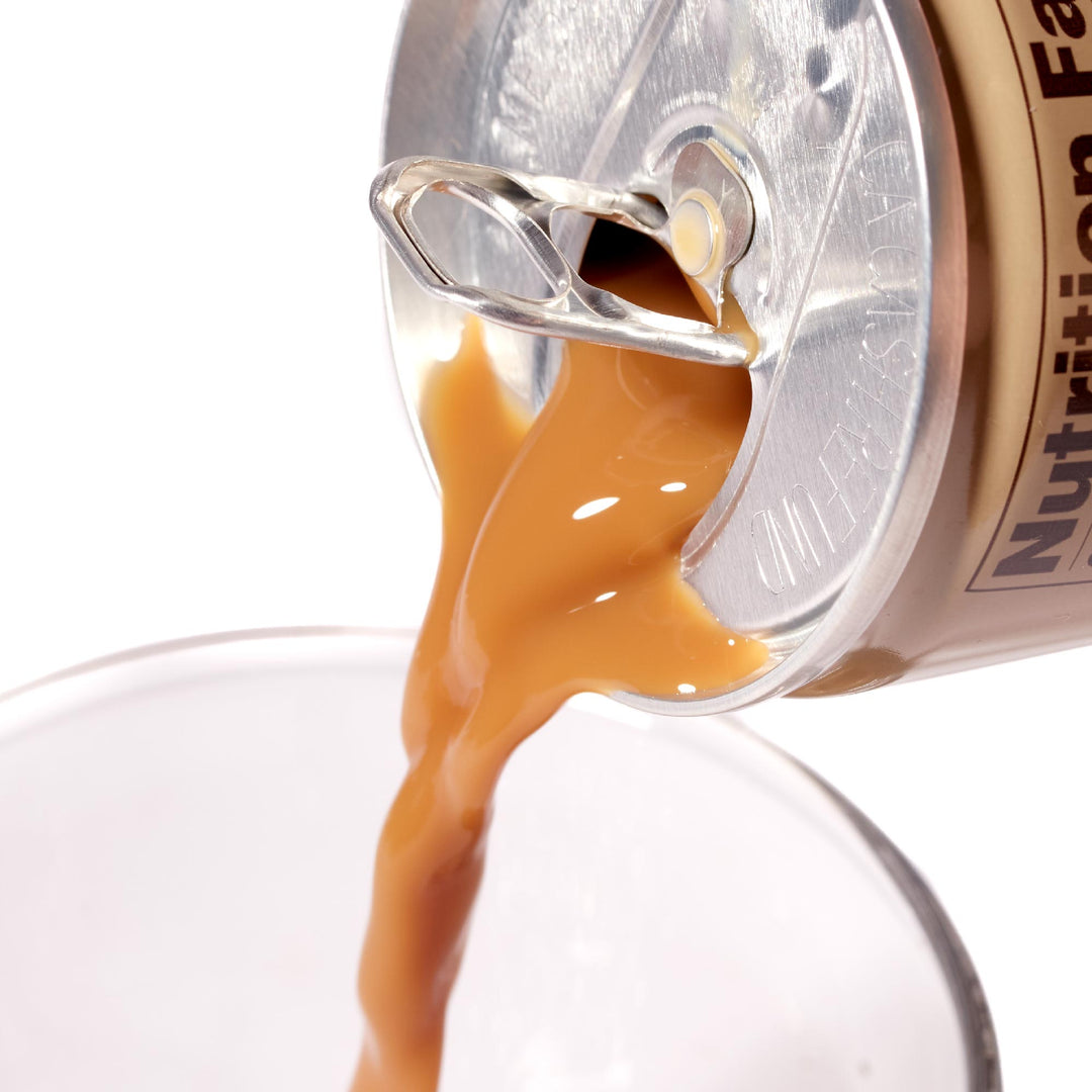 A can of Suntory BOSS Cold Cafe Au Lait being poured into a glass.