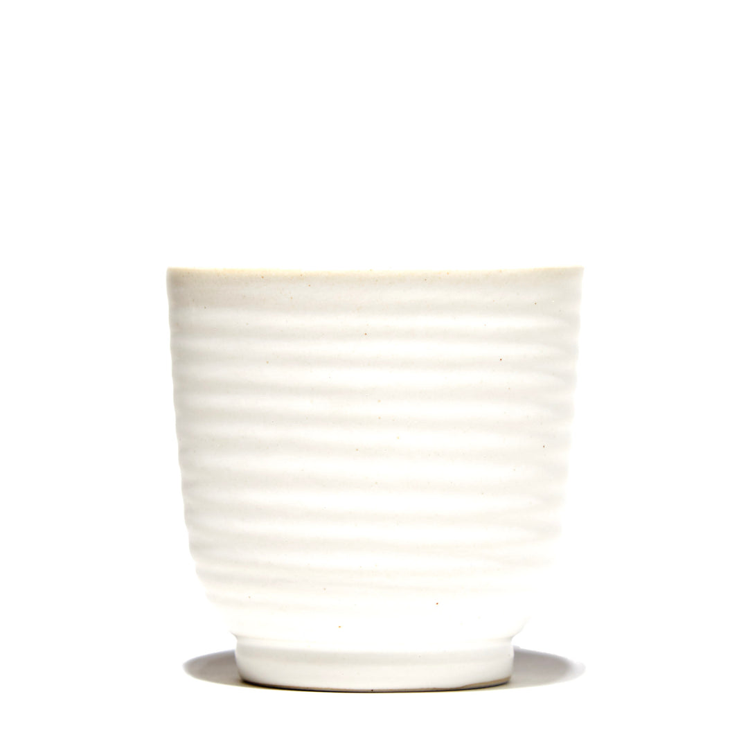 An Ivory Yunomi Tea Cup sitting on a white surface. (MTC)