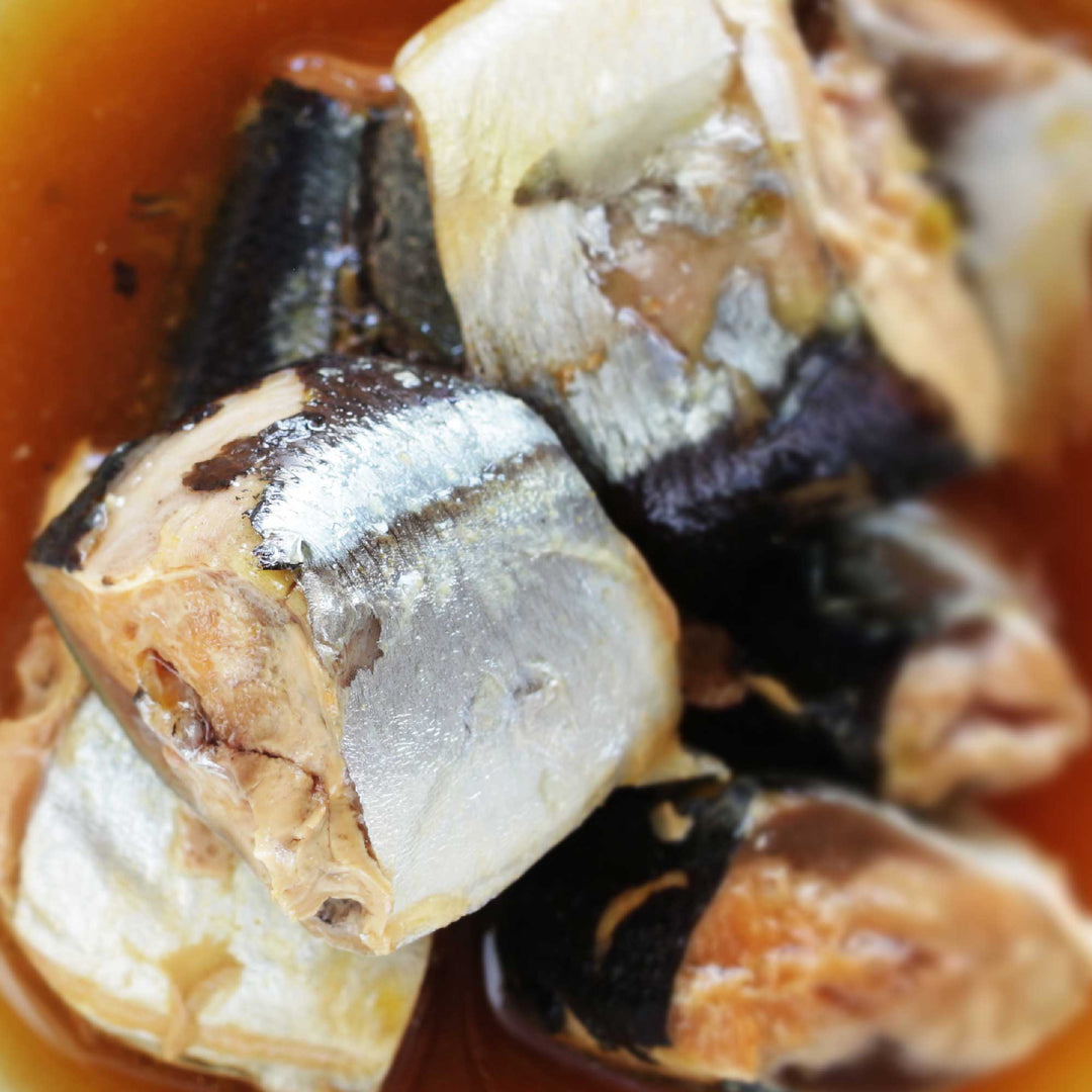 A close up of Kyokuyo Grilled Sanma Flavored with Yuzu Daikon Oroshi sardines in a sauce.
