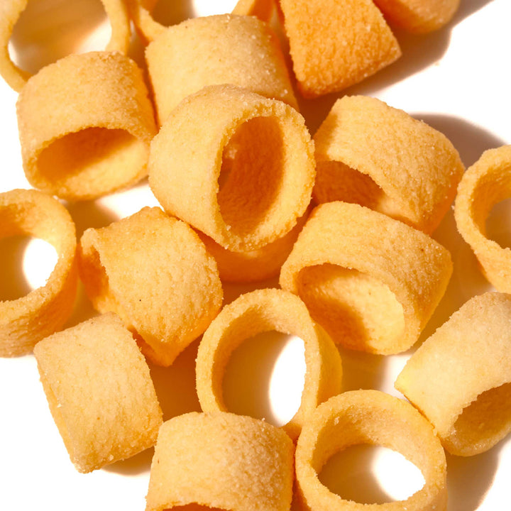 A pile of Tohato Poteko Mini Potato Rings: Uma Shio Salt on a white surface.