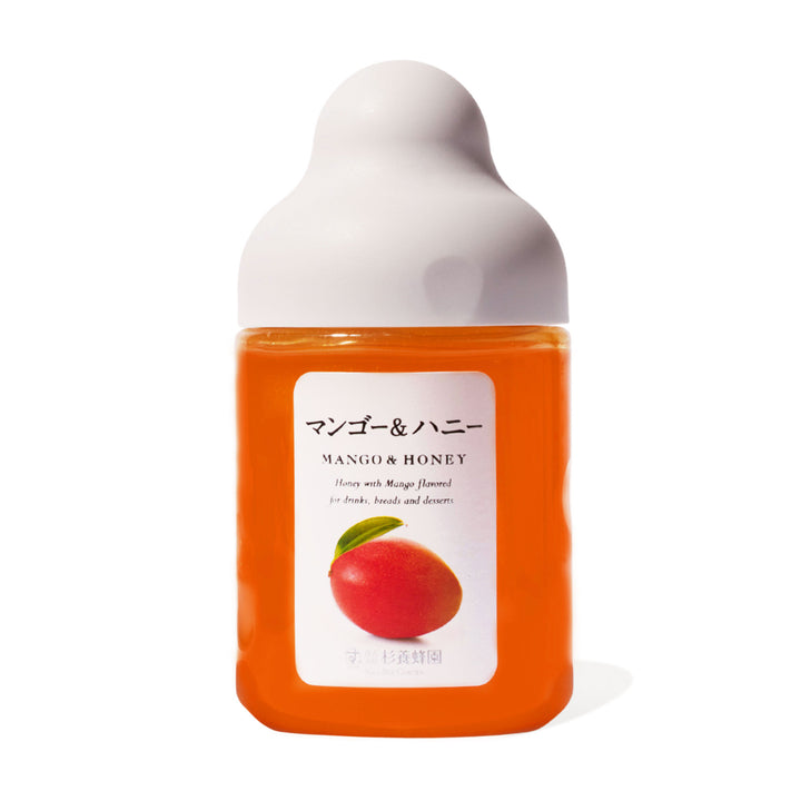 A bottle of Sugi Bee Garden Fruit Juice Infused Honey: Mango on a white background.