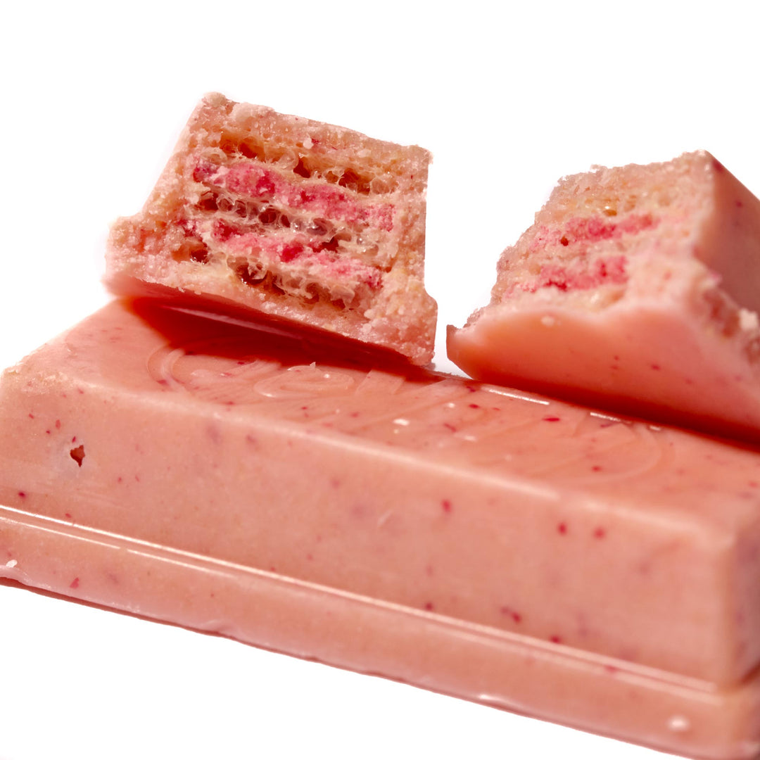 A pink Nestle Japan Kit Kat: Raspberry with a piece cut out of it.