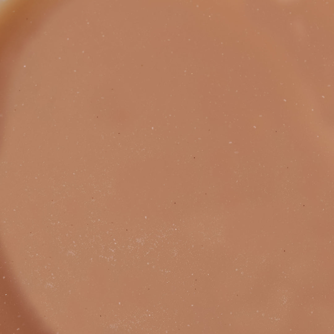 A close up of T. Grand Assam Oolong Milk Tea (6-pack) from the brand T. Grand, a tan colored liquid.
