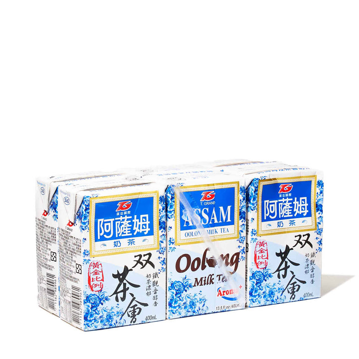 Four boxes of T. Grand Assam Oolong Milk Tea (6-pack) on a white background.
