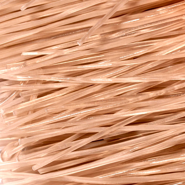 A close up of a pile of Surasang Sweet Potato Starch Noodles.