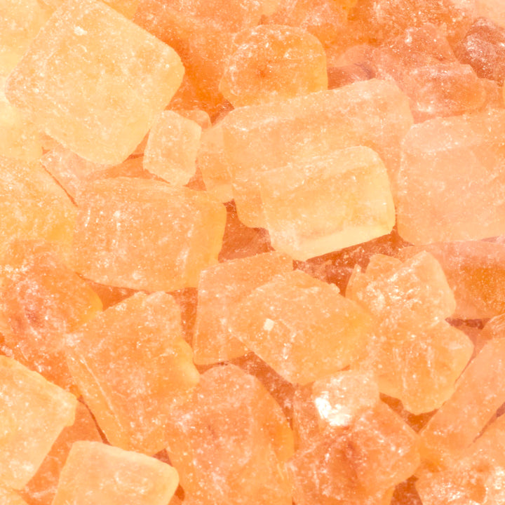 A close up image of a pile of Yu Yee Bing Tang Yellow Rock Sugar.