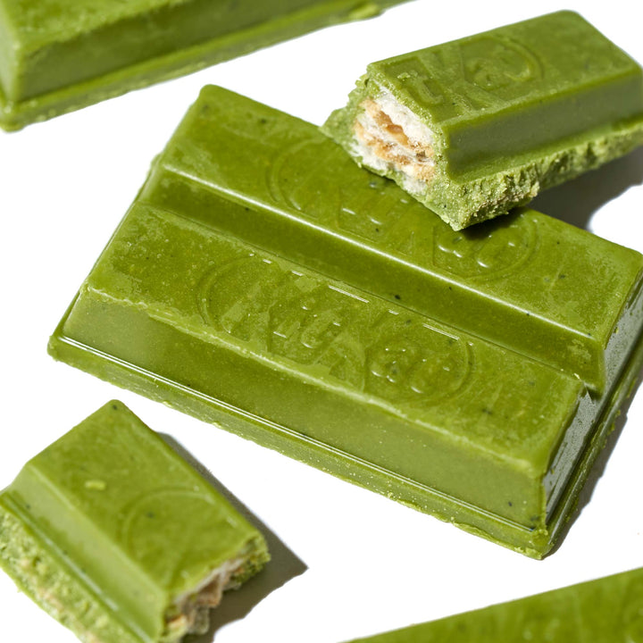 A Rich Green Tea Japanese Kit Kat with a bite taken out of it from Nestle Japan.