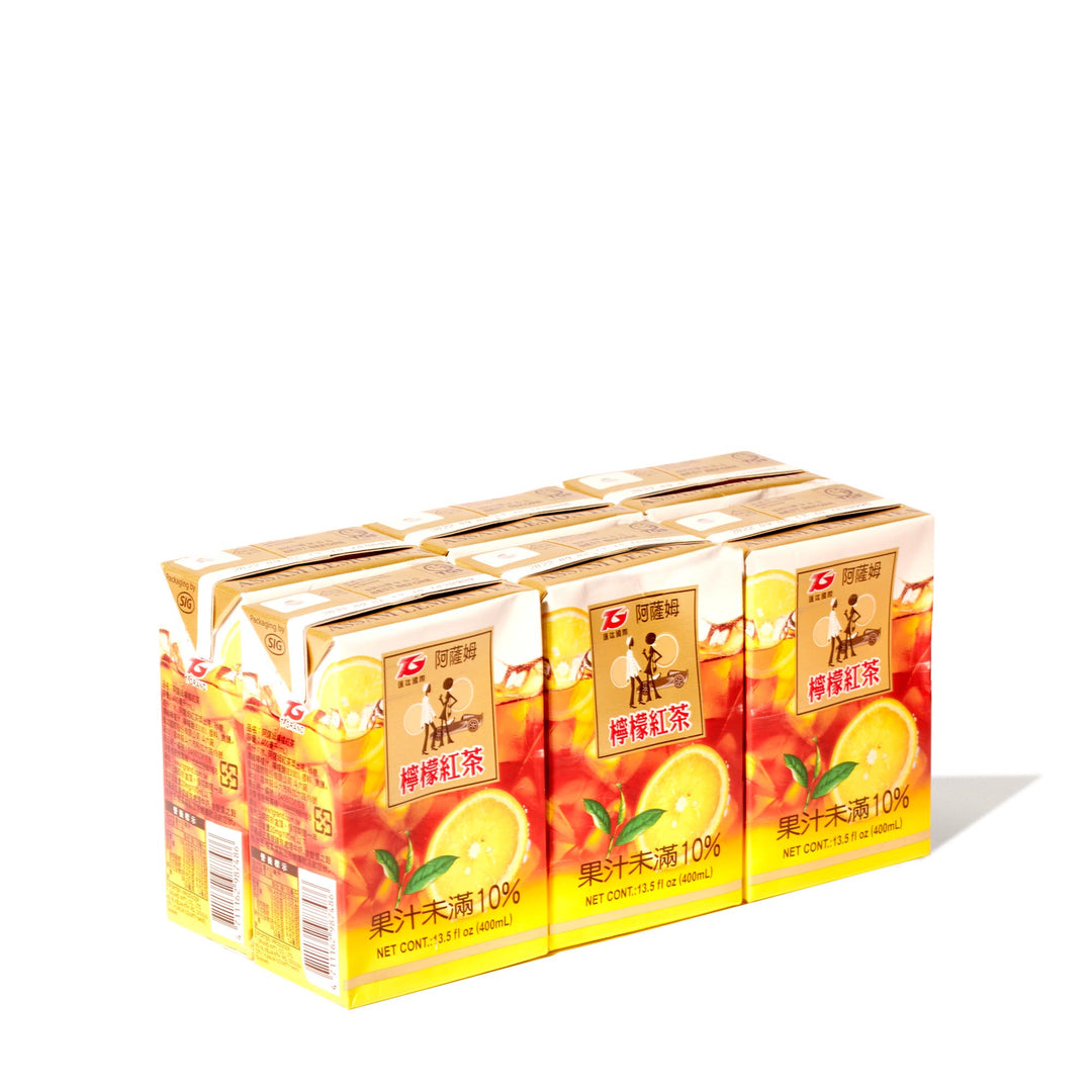 Four boxes of T. Grand Assam Lemon Black Tea (6-pack) on a white background.