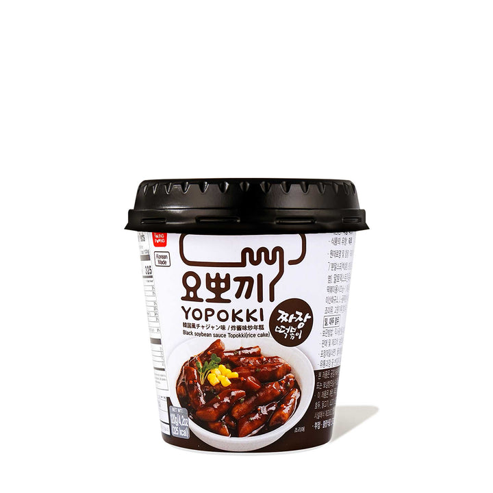 A container of Yopokki Instant Tteokbokki Rice Cake Cup: Jjajang Black Bean Paste on a white background.