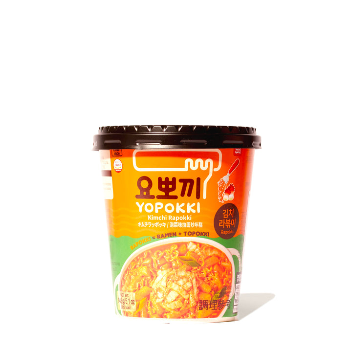 A cup of Yopokki Instant Rabokki Ramen and Tteokbokki Rice Cake Cup: Kimchi on a white background.