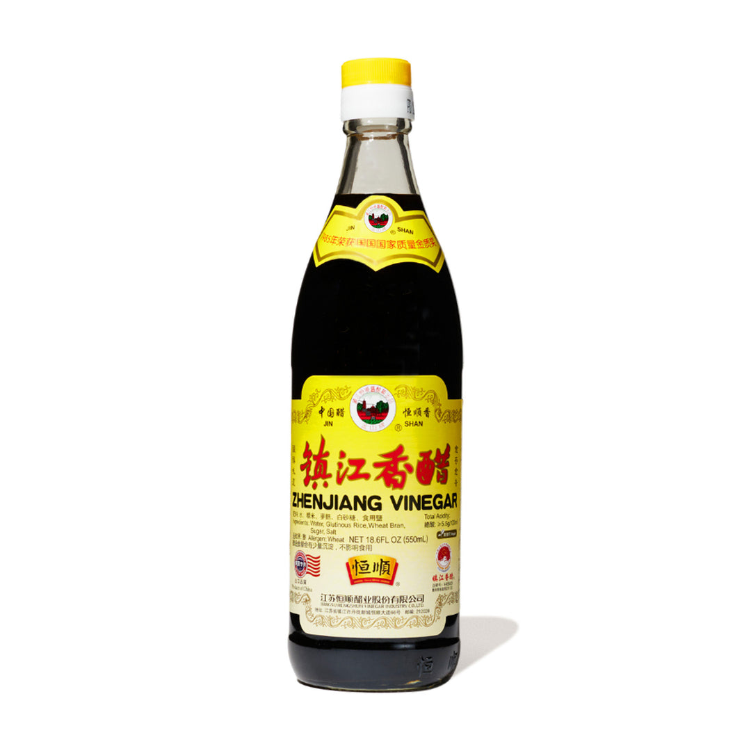A bottle of Jinshan Chinkiang Zhenjiang Vinegar on a white background.