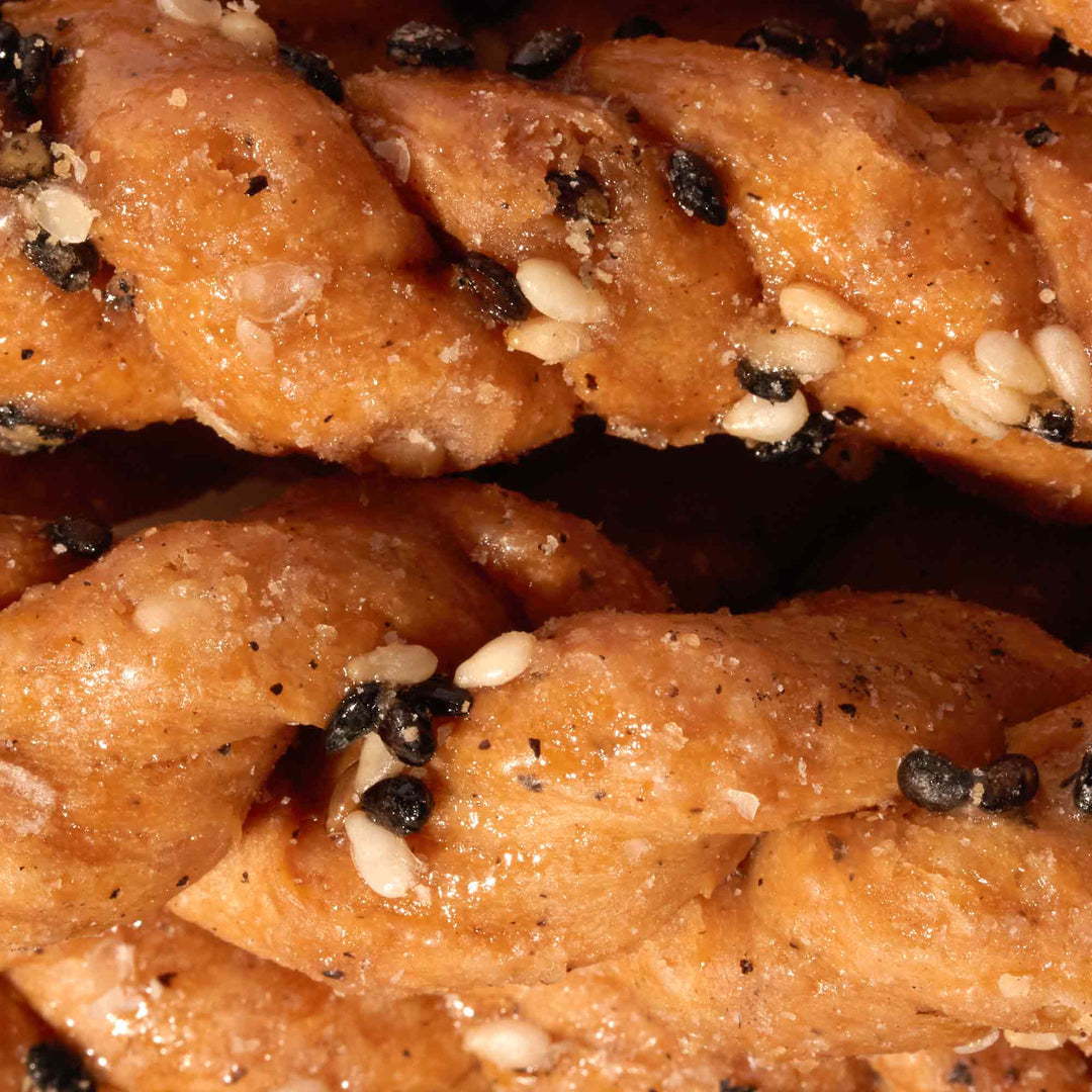 A close up of some Fu Wei braided bread with sesame seeds.