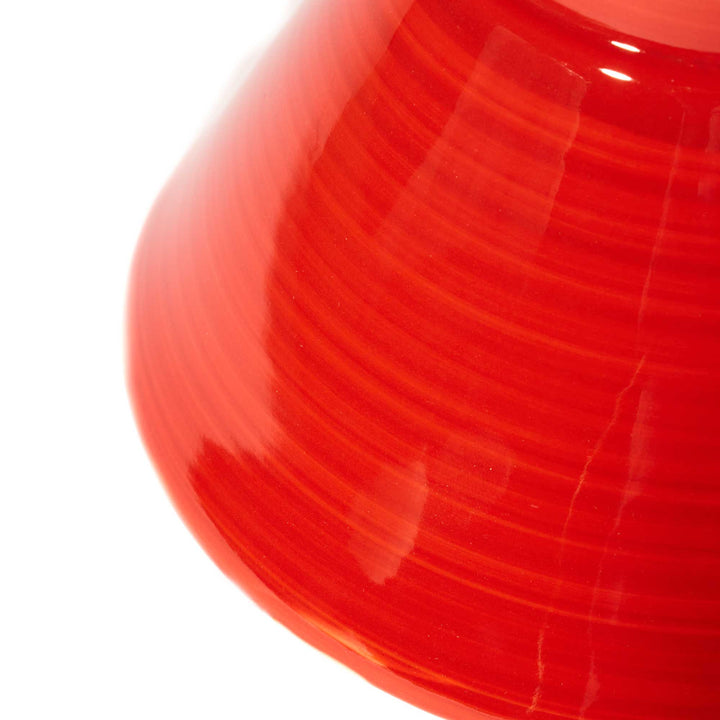 A Tall Red Ramen Bowl by Korin on a white surface.