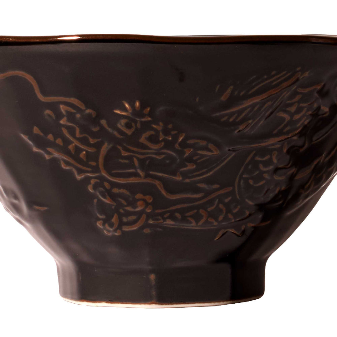 A Black Tenmoku Round Ramen Bowl with a dragon design on it by Korin.
