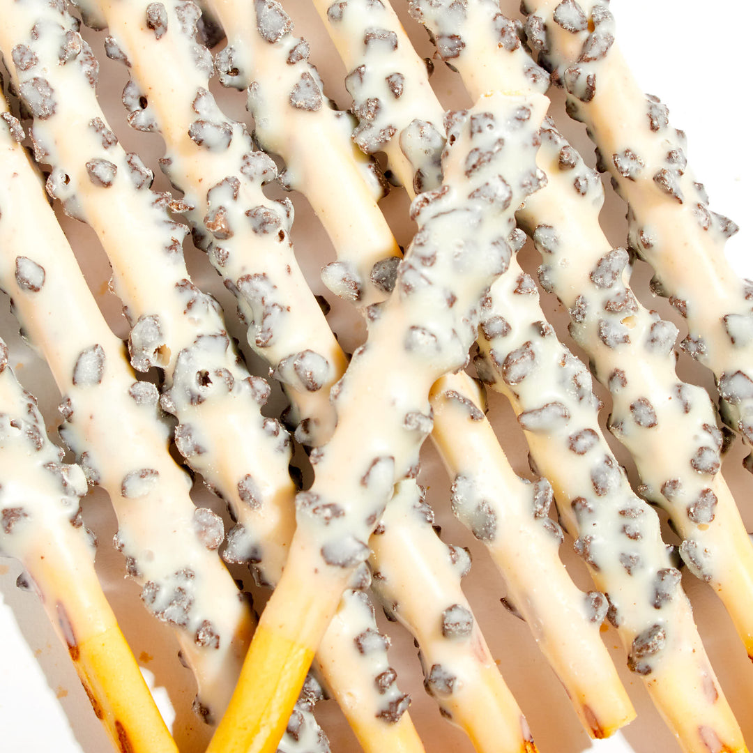 A plate of Lotte Pepero: White Chocolate Cookie sticks covered in chocolate and icing.