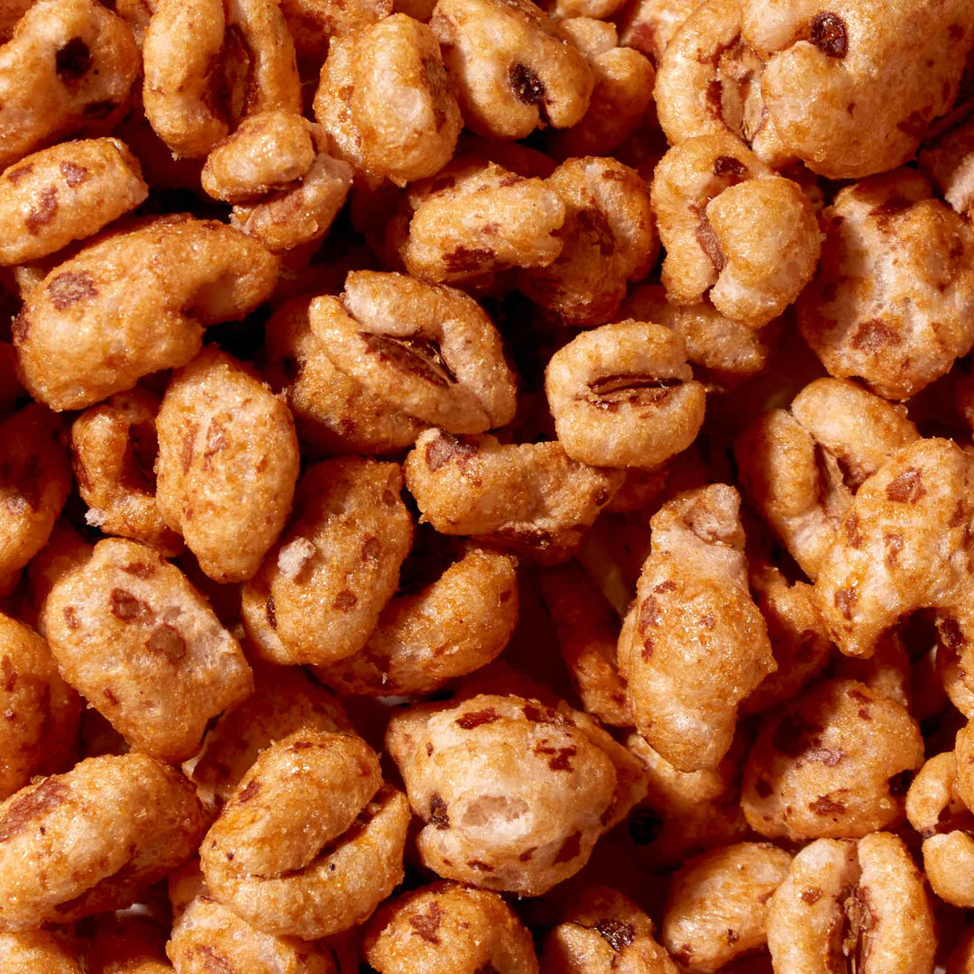 A pile of Crown Jolly Pong Cereal Snack on a white background.