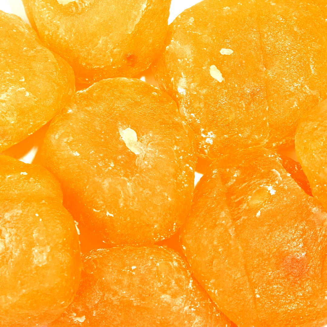 A pile of Seiki One-Bite Mochi: Mikan Orange on a white surface.