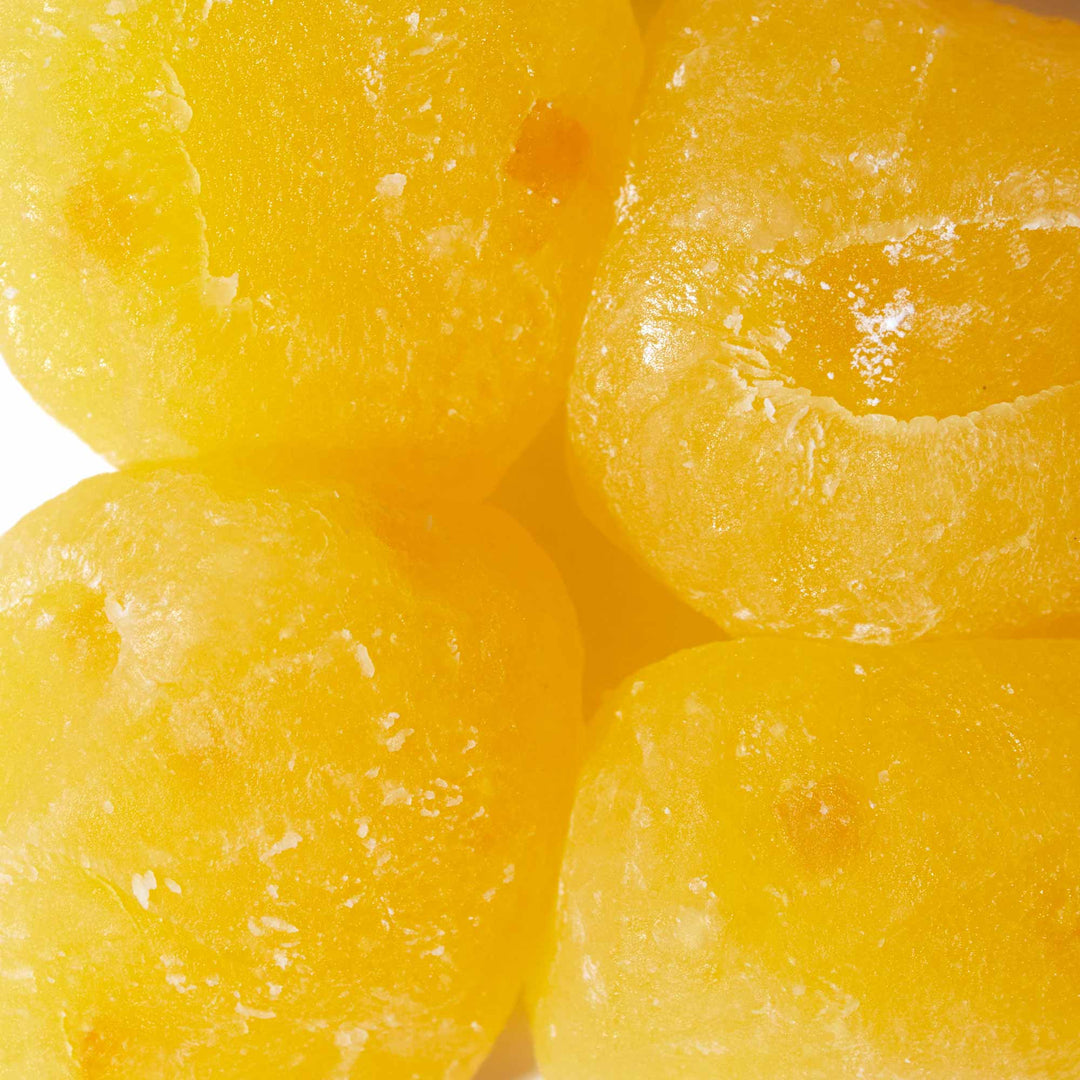 A group of Seiki One-Bite Mochi: Lemon cubes on a white surface.